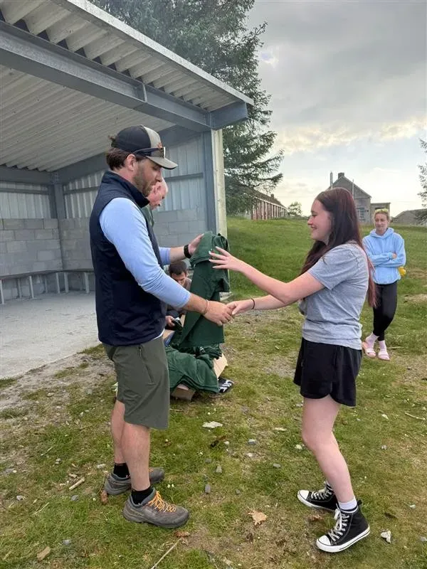 Ben handing out polos to the team
